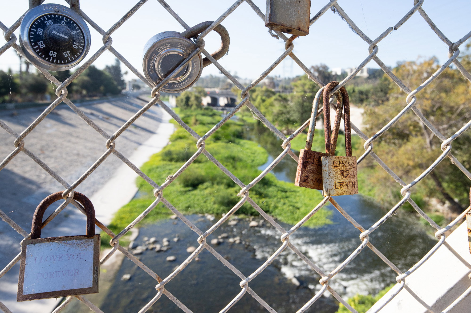 Locks on fence over LA River.
